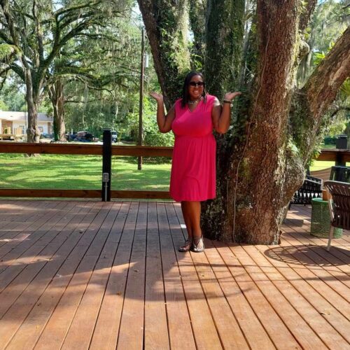Nicole standing in front the main tree at the treehouse.
