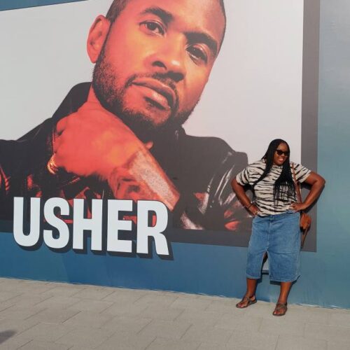 Myself standing in front of an Usher poster at his concert in Abu Dhabi.