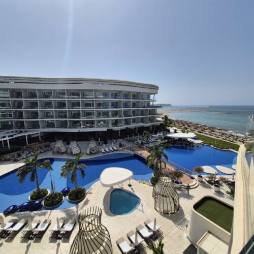 pool and exterior view of the St. Regis Muscat.