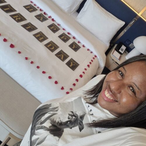 Photo of me with the Happy Birthday decorations in my room. 